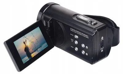 A black camcorder with its screen open, showing a silhouette of a person jumping in the water.