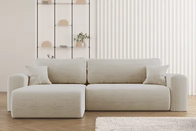 A beige sectional sofa with a ribbed texture is shown in a minimalist living room setting.