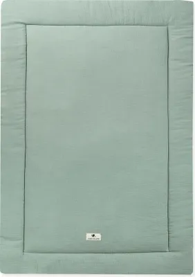 A flat lay of a green muslin play mat.
