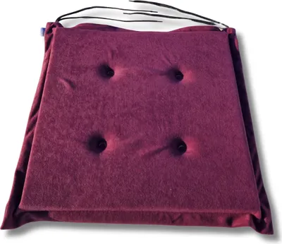 A square purple seat cushion with four tufted buttons is shown from a slightly elevated angle against a white background.