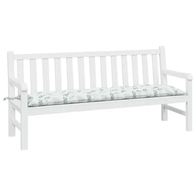 A white wooden bench with a cushion featuring a green leaf pattern.