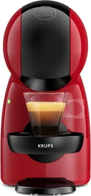 A red and black Krups coffee machine with a glass of espresso.