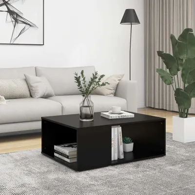 A modern living room scene with a black coffee table in the foreground, a sofa, and a floor lamp.