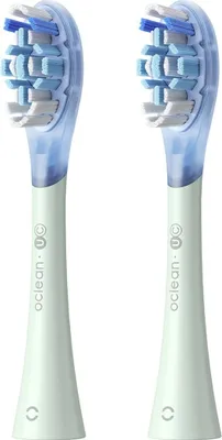 Two green and blue toothbrush heads are shown against a white background.