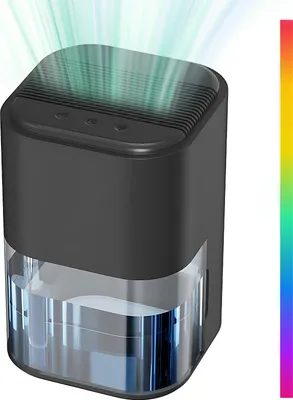 A black and clear dehumidifier with green light rays emanating from the top.