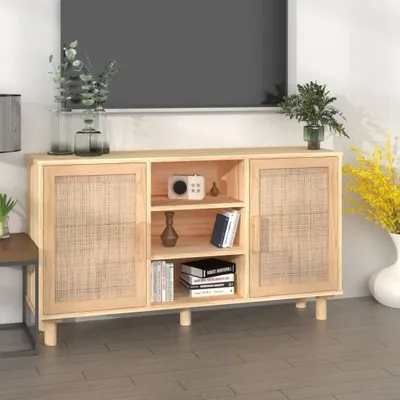 A wooden sideboard with rattan doors, decorated with plants and books, in a room setting.