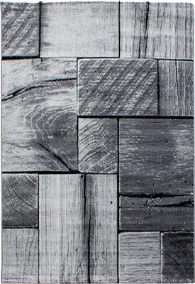 A close-up view of a textured rug with a 3D wood-block pattern.