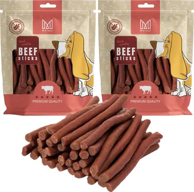 Two bags of dog treats with a pile of treats in front.