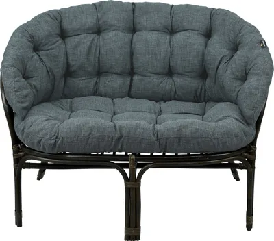 A gray cushion on a brown rattan sofa.