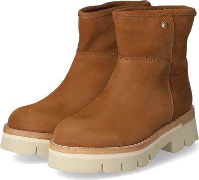 A pair of brown leather boots with thick white soles.