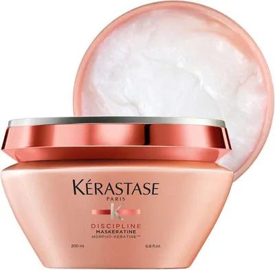 A product shot of a Kérastase hair mask jar with the lid slightly ajar, showing the product inside.