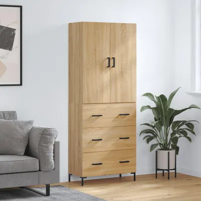 A tall, narrow wooden cabinet with two doors on top and three drawers below, placed in a room next to a sofa and a plant.