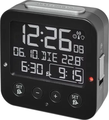 A black digital alarm clock with a negative display.