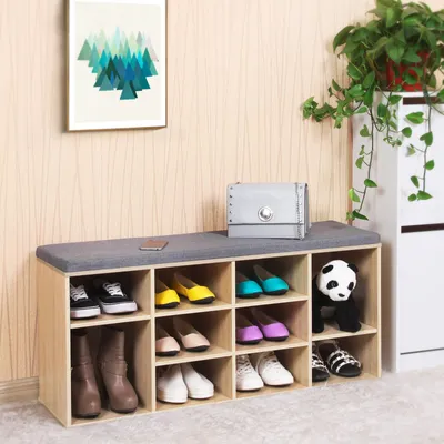 A shoe bench with 10 compartments, displaying various shoes and a panda plush toy.