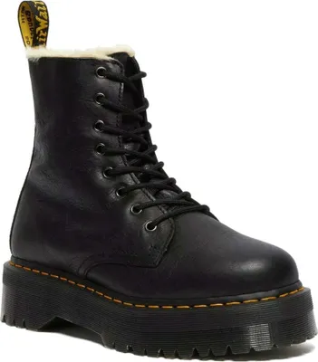 A black Dr. Martens boot with a platform sole and faux fur lining.