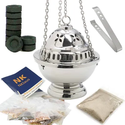 A collection of items for incense burning, including a censer, charcoal, and various incense resins.
