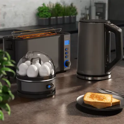A set of kitchen appliances, including a toaster, egg cooker, and kettle, on a countertop.