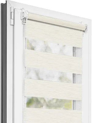 A close-up view of a cream and white striped roller blind installed in a white window frame.
