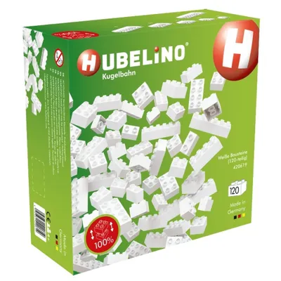 A product box for Hubelino Kugelbahn building blocks, showing a scattering of white blocks on a green background.