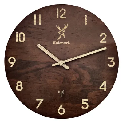 A wooden wall clock with a deer logo and the brand name "Holzwerk".