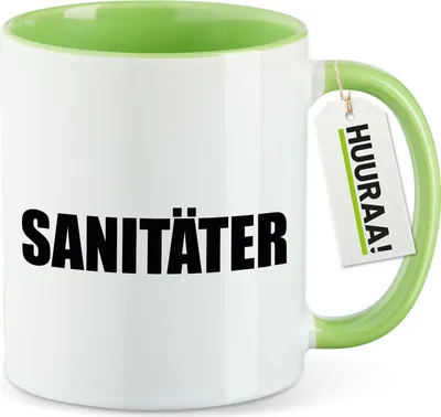 Produktbild von Huuraa Kaffeetasse Sanitäter Schriftzug 330ml Grün Keramik Kaffeebecher Geschenkidee