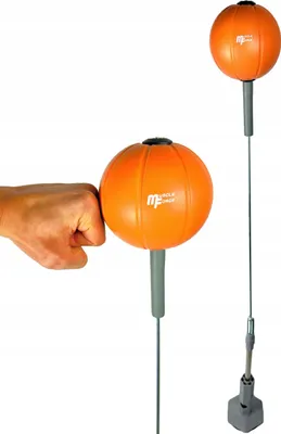A hand punching an orange reflex ball on a stand, with another reflex ball in the background.