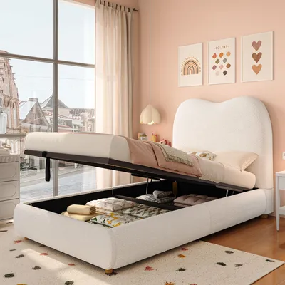 A bedroom scene with a white upholstered bed frame open to reveal storage underneath. The room has pink walls and a large window with sheer curtains.