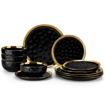 A set of black ceramic dishes with gold trim, arranged on a white background.