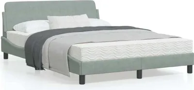 A light gray upholstered bed frame with a headboard, mattress, and bedding.