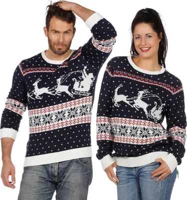 A man and a woman are posing in front of a white background, both wearing matching Christmas sweaters.