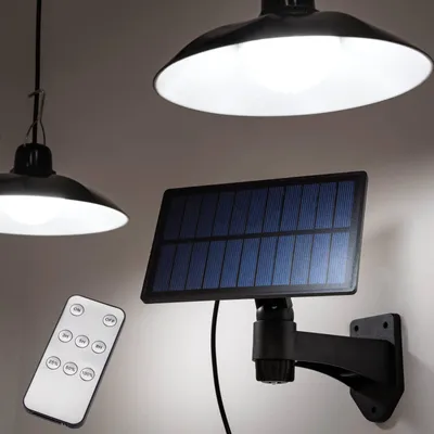 A solar-powered hanging lamp with a remote control, shown mounted on a wall.