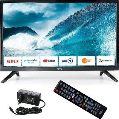 A television set with its accessories, including a remote control and power adapter, displayed on a white background.