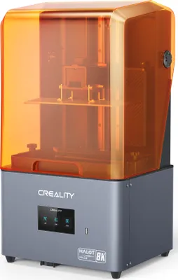 A 3D printer with an orange translucent cover.