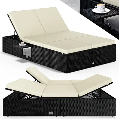 A double chaise lounge with a small side table and a cup of coffee.