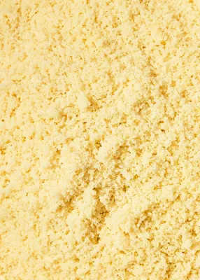 A close-up, overhead view of finely ground, blanched almonds.