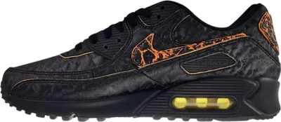A side view of a black Nike Air Max 90 sneaker with orange accents.