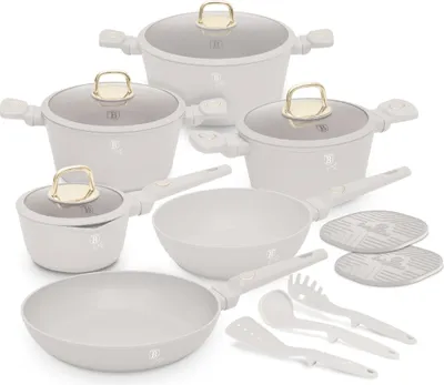 A collection of white cookware with gold accents, including pots, pans, and utensils, arranged on a white background.