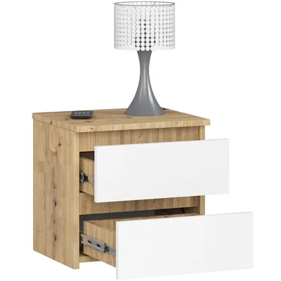 A bedside table with two drawers and a lamp on top.