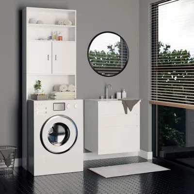 A laundry room with a washing machine and a storage cabinet.