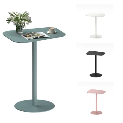 A collection of side tables in different colors, with one table in the foreground featuring a vase of flowers, a magazine, and a cup of coffee.