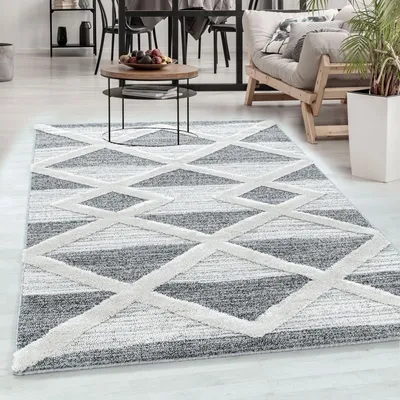 A living room scene with a rug in the foreground, a coffee table, and a sofa in the background.