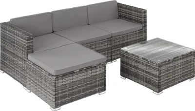 A gray rattan sectional sofa with cushions and a matching coffee table are shown against a white background.