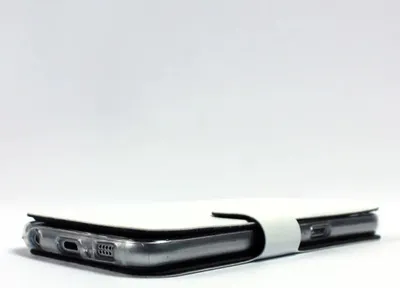A close-up side view of a brown leather phone case on a white background.