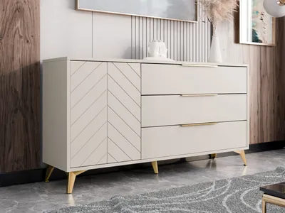 A modern sideboard with a herringbone patterned door and three drawers, set against a neutral background with wood paneling and a framed artwork.