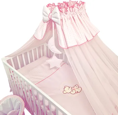 A baby crib with bedding and a canopy.