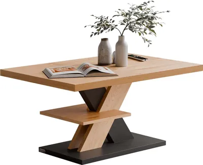 A modern coffee table with a unique geometric base and a wooden top, decorated with two vases and a book.