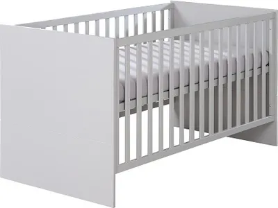 A white baby crib with a mattress inside, shown from a side angle against a white background.