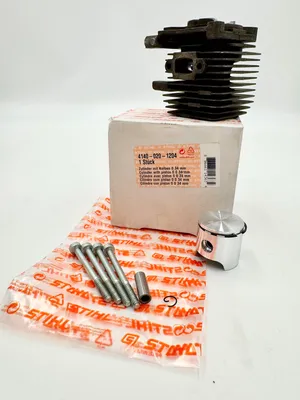 A STIHL cylinder and piston kit is displayed on a white background, with the box and packaging visible.