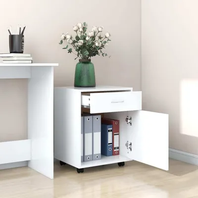 A white filing cabinet with an open drawer and door, next to a white desk.