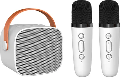 A white portable speaker with an orange handle and two white microphones are displayed against a white background.